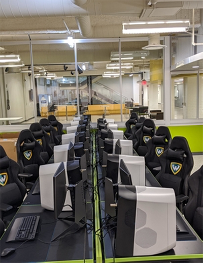 Row of gaming computers and high-back gaming chairs